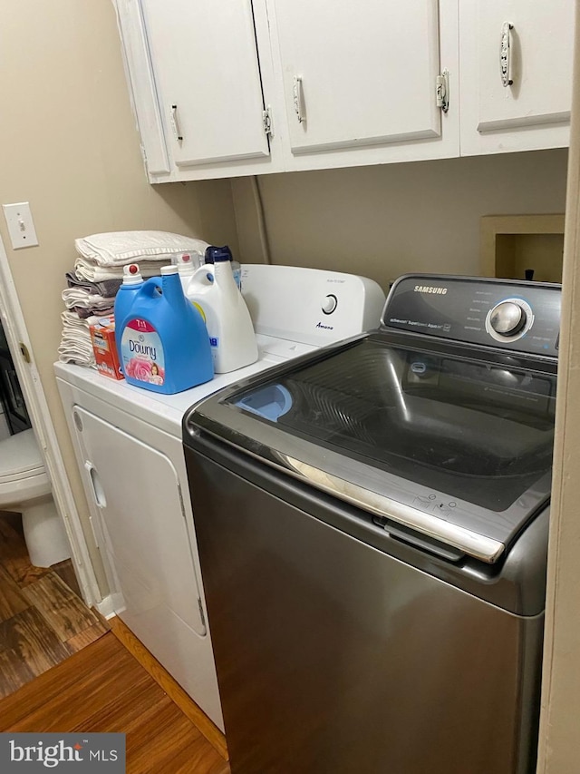 4 Highland Pl, Indian Head, MD 20640 - laundry area featuring separate washer and dryer, wood finished floors, and cabinet space
