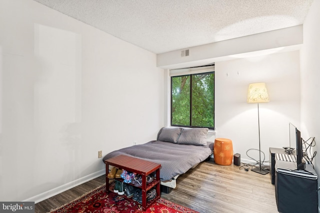 15301 Beaverbrook Ct Unit 92-3K, Silver Spring, MD 20906 - bedroom with wood finished floors and a textured ceiling