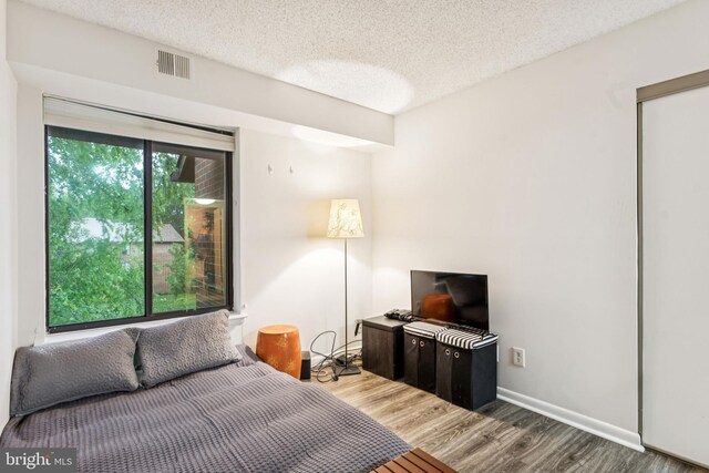 15301 Beaverbrook Ct Unit 92-3K, Silver Spring, MD 20906 - bedroom with wood finished floors and a textured ceiling
