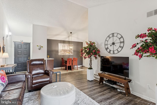 15301 Beaverbrook Ct Unit 92-3K, Silver Spring, MD 20906 - living room with dark wood-type flooring, a chandelier, and a baseboard heating unit