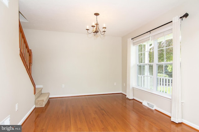 43 Oak Crest Ct, Hanover, PA 17331 - unfurnished room with stairs, wood finished floors, and a chandelier
