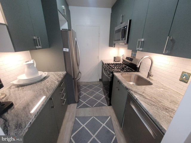 7900 Old York Rd Unit 504-A, Elkins Park, PA 19027 - kitchen featuring stainless steel appliances, light wood-style floors, tasteful backsplash, and light stone counters