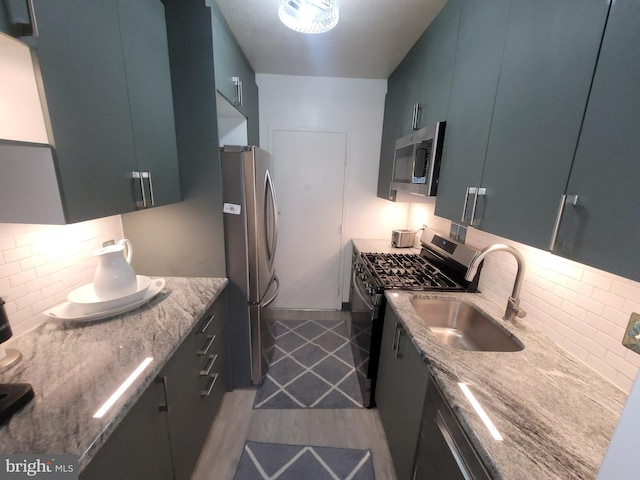 7900 Old York Rd Unit 504-A, Elkins Park, PA 19027 - kitchen with appliances with stainless steel finishes, wood finished floors, tasteful backsplash, and light stone countertops