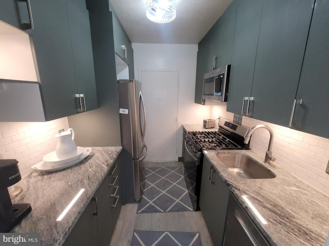 7900 Old York Rd Unit 504-A, Elkins Park, PA 19027 - kitchen with appliances with stainless steel finishes, backsplash, wood finished floors, and light stone counters
