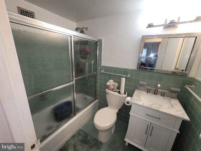 7900 Old York Rd Unit 504-A, Elkins Park, PA 19027 - bathroom with tile walls, vanity, enclosed tub / shower combo, tile patterned floors, and wainscoting