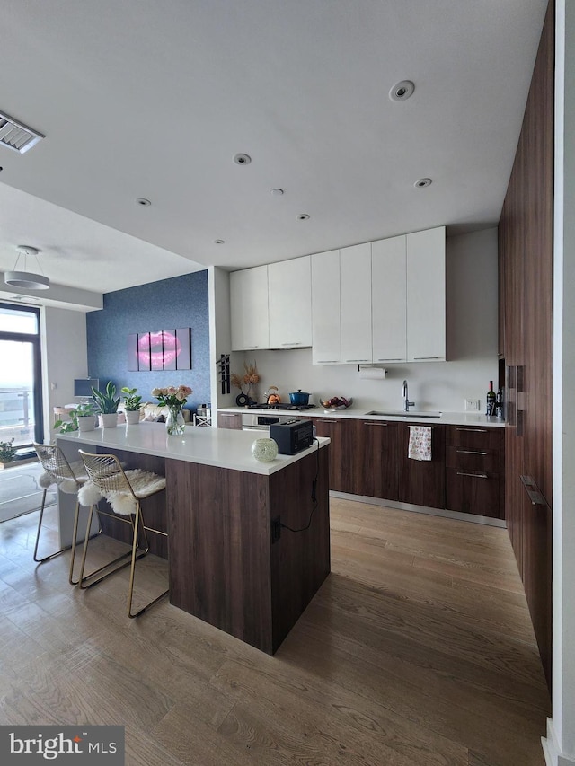 1650 Silver Hill Dr Unit 1608, Mclean, VA 22102 - kitchen with modern cabinets, white cabinetry, light countertops, light wood-style flooring, and recessed lighting
