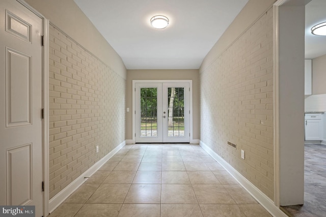 3010 Forrest Ave, Dover, DE 19904 - entryway featuring brick wall, french doors, and light tile patterned floors