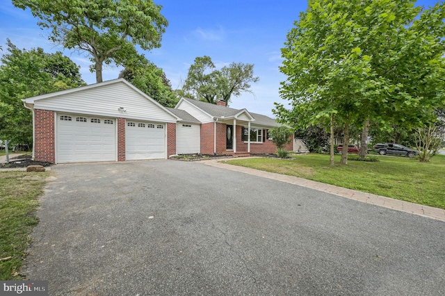 3010 Forrest Ave, Dover, DE 19904 - ranch-style house with an attached garage, asphalt driveway, a front lawn, and brick siding