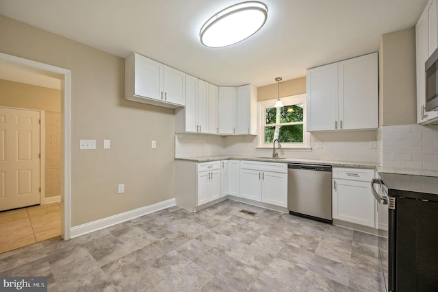 3010 Forrest Ave, Dover, DE 19904 - kitchen featuring appliances with stainless steel finishes, decorative backsplash, and white cabinetry