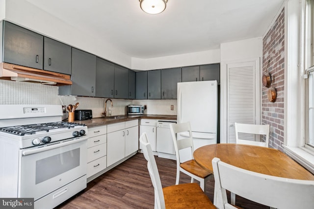 6022 Mccallum St, Philadelphia, PA 19144 - kitchen featuring white appliances, under cabinet range hood, dark wood-style floors, dark countertops, and decorative backsplash