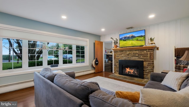 1226 Brownsville Rd, Feasterville Trevose, PA 19053 - living area with a baseboard radiator, a stone fireplace, wood finished floors, and recessed lighting