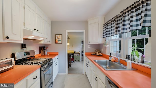 1226 Brownsville Rd, Feasterville Trevose, PA 19053 - kitchen with stainless steel gas range, under cabinet range hood, white cabinetry, and light countertops