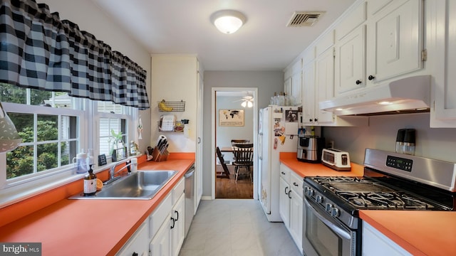1226 Brownsville Rd, Feasterville Trevose, PA 19053 - kitchen with stainless steel range with gas cooktop, under cabinet range hood, light marble finish floors, white cabinets, and light countertops