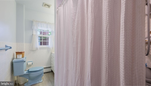 1226 Brownsville Rd, Feasterville Trevose, PA 19053 - full bath with tile walls, a baseboard heating unit, and a wainscoted wall