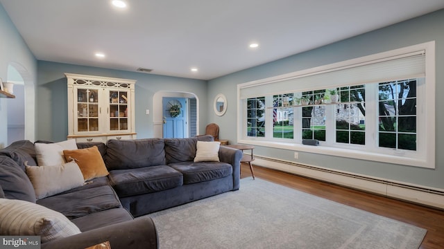 1226 Brownsville Rd, Feasterville Trevose, PA 19053 - living room with arched walkways, a baseboard heating unit, wood finished floors, and recessed lighting
