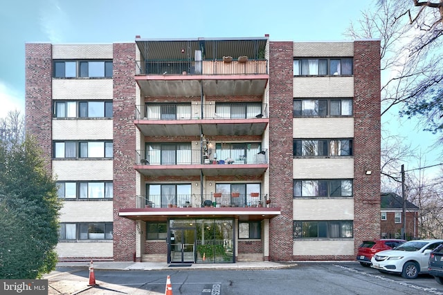 8308 Flower Ave Unit 401, Takoma Park, MD 20912 - view of apartment building / complex featuring uncovered parking