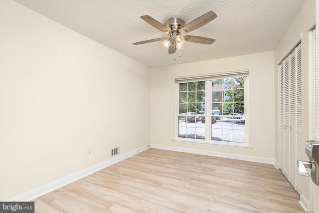 49 Joyner Ct, Lawrence, NJ 08648 - unfurnished bedroom with light wood-type flooring, a closet, a textured ceiling, and a ceiling fan