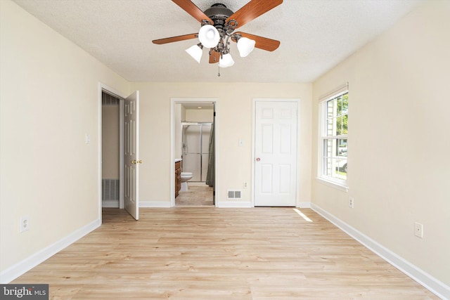 49 Joyner Ct, Lawrence, NJ 08648 - unfurnished bedroom with light wood-style flooring, ensuite bathroom, a textured ceiling, and a ceiling fan