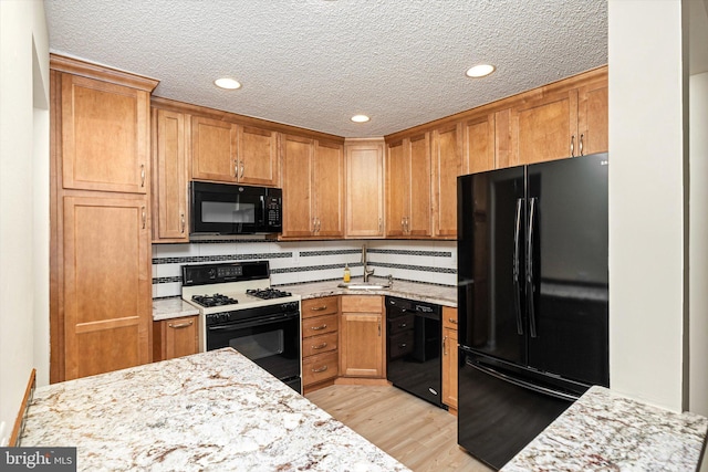 49 Joyner Ct, Lawrence, NJ 08648 - kitchen featuring black appliances, recessed lighting, light wood finished floors, light stone counters, and a textured ceiling