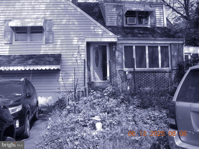 63 N Main St, Quakertown, PA 18951 - view of front facade with a shingled roof and brick siding