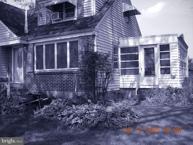 63 N Main St, Quakertown, PA 18951 - view of property exterior with brick siding and a sunroom