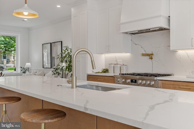4308 4th St NW, Washington, DC 20011 - kitchen featuring premium range hood, light stone countertops, decorative backsplash, white cabinets, and recessed lighting