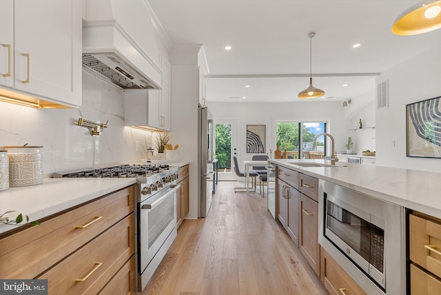 4308 4th St NW, Washington, DC 20011 - kitchen featuring premium appliances, custom range hood, light wood-style floors, tasteful backsplash, and recessed lighting
