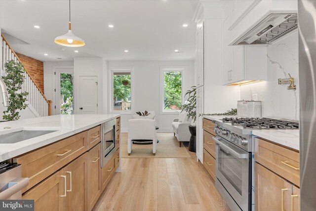 4308 4th St NW, Washington, DC 20011 - kitchen featuring appliances with stainless steel finishes, custom range hood, light wood-type flooring, light stone counters, and recessed lighting