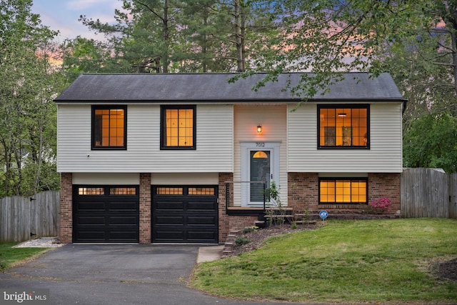 7012 Vantage Dr, Alexandria, VA 22306 - split foyer home featuring brick siding, a garage, and driveway