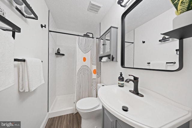 7012 Vantage Dr, Alexandria, VA 22306 - full bath featuring a shower stall, vanity, wood finished floors, and a textured ceiling