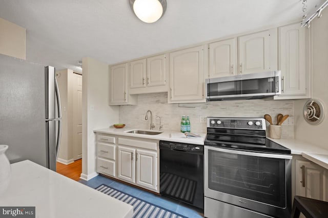 7012 Vantage Dr, Alexandria, VA 22306 - kitchen featuring appliances with stainless steel finishes, light countertops, and backsplash