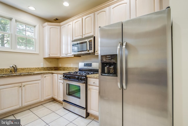 19967 Sandy Bottom Cir Unit 103, Rehoboth Beach, DE 19971 - kitchen with appliances with stainless steel finishes, light stone counters, light tile patterned floors, and recessed lighting