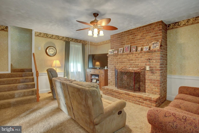 8029 Molly Pitcher Hwy, Shippensburg, PA 17257 - carpeted living area with ceiling fan, a wainscoted wall, a brick fireplace, stairs, and wallpapered walls