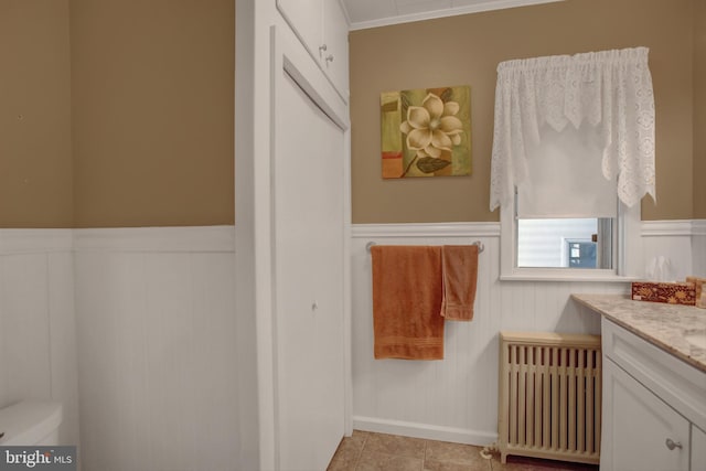 8029 Molly Pitcher Hwy, Shippensburg, PA 17257 - bathroom featuring a wainscoted wall, vanity, radiator heating unit, and ornamental molding