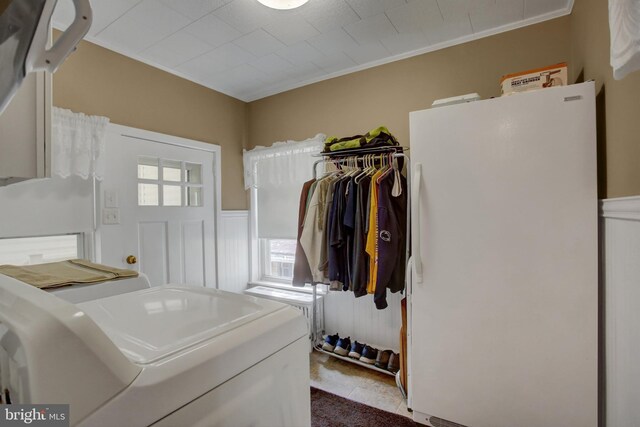 8029 Molly Pitcher Hwy, Shippensburg, PA 17257 - washroom with healthy amount of natural light, a wainscoted wall, crown molding, tile patterned flooring, and washing machine and clothes dryer