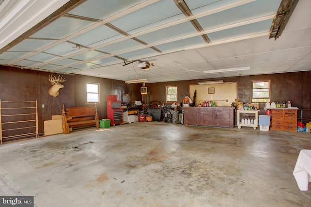8029 Molly Pitcher Hwy, Shippensburg, PA 17257 - garage featuring a workshop area, wood walls, and a garage door opener