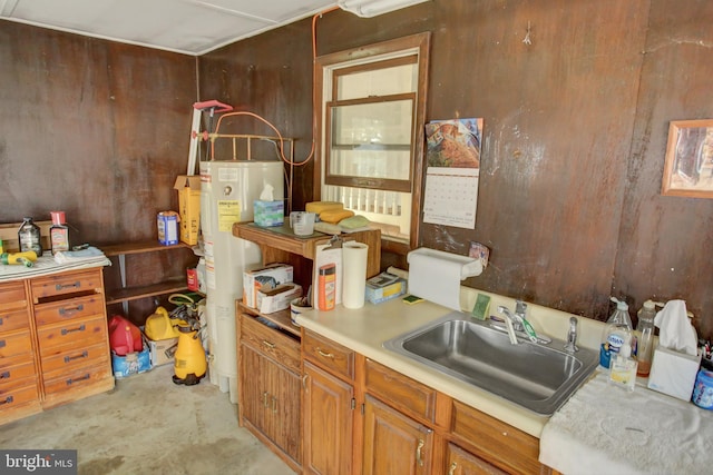 8029 Molly Pitcher Hwy, Shippensburg, PA 17257 - kitchen with electric water heater, unfinished concrete floors, light countertops, and brown cabinetry