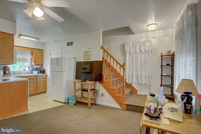 8029 Molly Pitcher Hwy, Shippensburg, PA 17257 - kitchen featuring freestanding refrigerator, a ceiling fan, light carpet, and light countertops