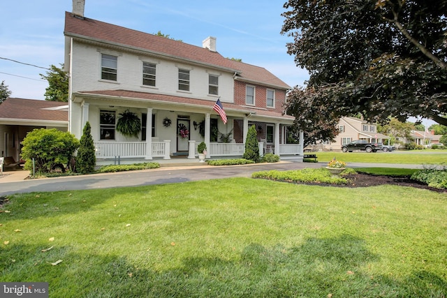 8029 Molly Pitcher Hwy, Shippensburg, PA 17257 - view of front of home featuring a chimney, covered porch, a front lawn, and brick siding