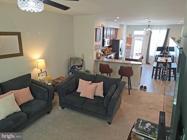 18316 Reaper Hill Ct, Triangle, VA 22172 - living room featuring light colored carpet, a ceiling fan, a chandelier, and recessed lighting
