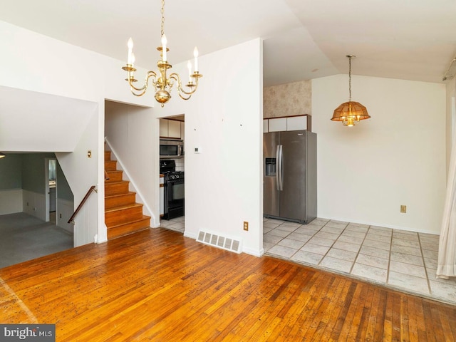 2868 Senak Rd, Abington, PA 19001 - unfurnished living room with a chandelier, light wood-style floors, stairs, and lofted ceiling