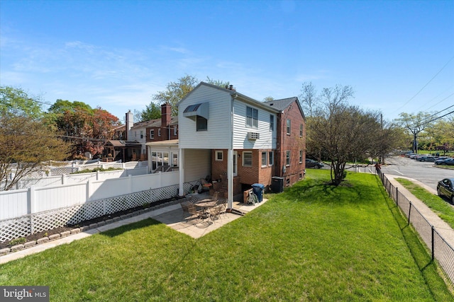 733 S Fayette St, Alexandria, VA 22314 - view of property exterior featuring a fenced backyard, a patio, and brick siding
