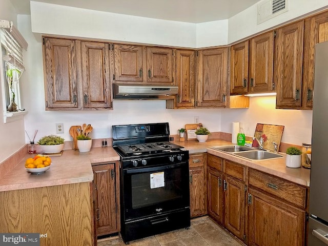 733 S Fayette St, Alexandria, VA 22314 - kitchen with gas stove, ventilation hood, light countertops, and brown cabinetry