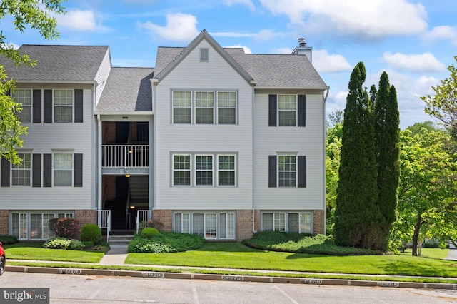 31 Beagle Run Unit 88, Nottingham, MD 21236 - view of front facade with a chimney, brick siding, and a front lawn