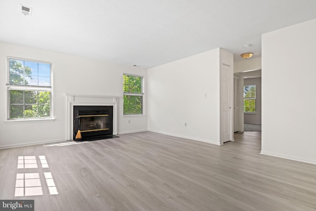 31 Beagle Run Unit 88, Nottingham, MD 21236 - unfurnished living room featuring wood finished floors and a fireplace with flush hearth