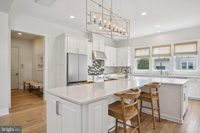 41550 Hepatica Ct, Ashburn, VA 20148 - kitchen with freestanding refrigerator, white cabinets, recessed lighting, under cabinet range hood, and tasteful backsplash