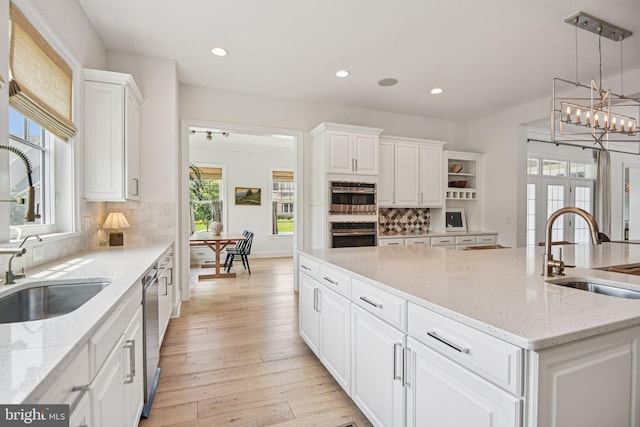 41550 Hepatica Ct, Ashburn, VA 20148 - kitchen with stainless steel double oven, white cabinetry, a center island, backsplash, and recessed lighting