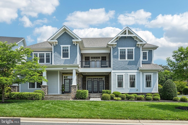 41550 Hepatica Ct, Ashburn, VA 20148 - view of front facade featuring a balcony, a front lawn, roof with shingles, and covered porch