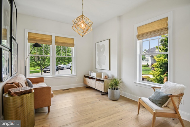 41550 Hepatica Ct, Ashburn, VA 20148 - living area with light wood-type flooring and a chandelier