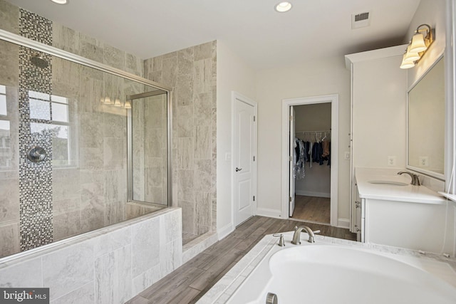 41550 Hepatica Ct, Ashburn, VA 20148 - bathroom with a stall shower, vanity, a garden tub, recessed lighting, and wood finished floors